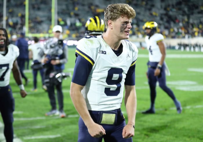 J.J. McCarthy flexes his arms in celebration